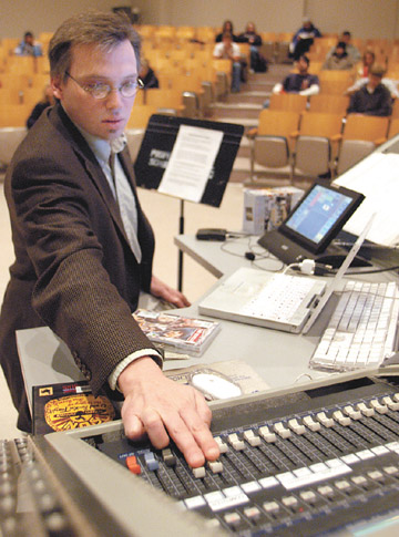 Associate Professor Scott Anderson turns up the volume on a Beatles DVD during the History of Rock Music class Feb...