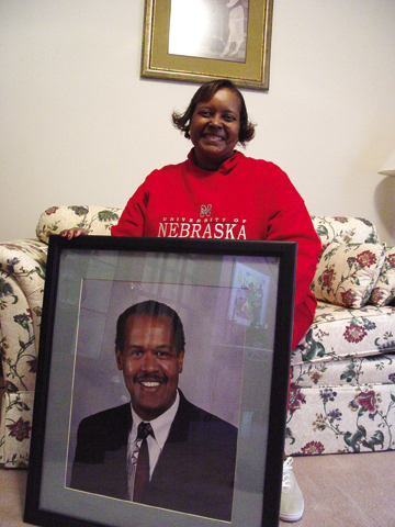 Colleen Jones sits in her home with a picture of her husband Melvin W. Jones. Photo by Troy Fedderson, University...