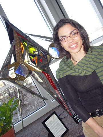 GLASS AND STEEL - Marita Sanchez sits by 