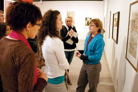 COLLEGE NIGHT - Docent Kestrel Lemen (right), a senior art major from Lincoln, engages students with the question, 