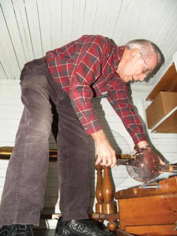 ATTIC FIND - Eugene Rudd examines an X-ray tube in one of the Brace Hall storage closets used to house the...