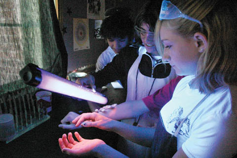 GLOWING PROGRAM - Potter-Dix Public Schools students work with Glo Germ and a black light. The experiment is part of a...