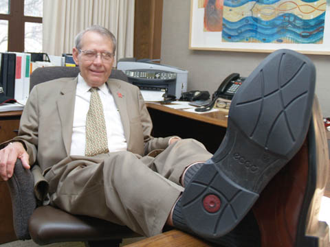 KICKING BACK - Herb Howe, associate to the chancellor, rests behind Chancellor Harvey Perlman's desk. After 38 years of service to...