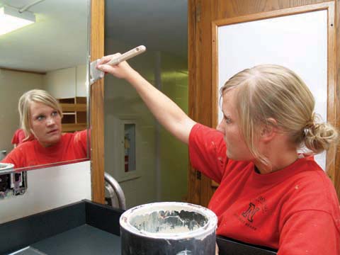SUMMER COAT - Mackenzie Tillman, a summer employee in University Housing, paints around a mirror in Abel Hall on July 19...